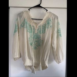 White blouse with teal design